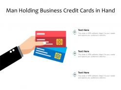 Man holding business credit cards in hand