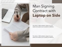 Man signing contract with laptop on side