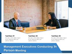 Management executives conducting in person meeting