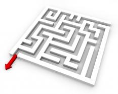 Maze with red arrow way out displaying solution stock photo