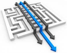 Maze with three arrows with blue arrow leading shows business success stock photo