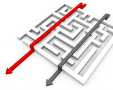 Maze with two arrows with red arrow leading displaying leadership stock photo