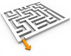 Maze with yellow arrow way out to show problem solution stock photo