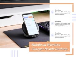 Mobile on wireless charger beside desktop