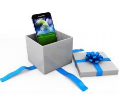 Mobile phone inside the gift box displaying gifting concept stock photo