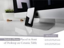 Mobile phone placed in front of desktop on ceramic table