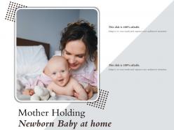 Mother holding newborn baby at home