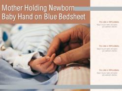 Mother holding newborn baby hand on white bedsheet