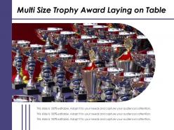Multi size trophy award laying on table