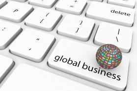 Multicolor globe on white keyboard with global business key stock photo