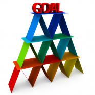 Multicolored cards pyramid with word goal on top stock photo