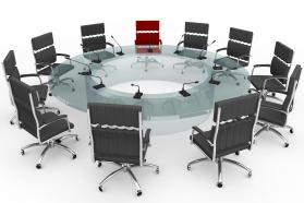 Multiple chairs in circle with one red chair stock photo
