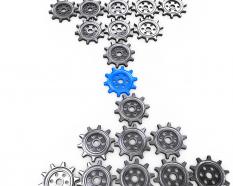 Multiple gears with one blue gear in the middle as leader stock photo