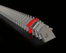 Multiple house shaped dominoes with one red to show leadership stock photo