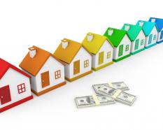 Multiple houses as housing group with dollars stock photo