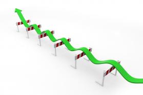 Multiple hurdles with green progressive arrow showing growth stock photo