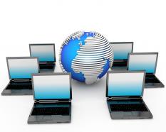 Multiple laptops with globe networking concept stock photo