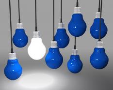 One glowing bulb as innovation with blue bulbs stock photo
