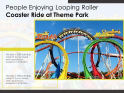 People enjoying looping roller coaster ride at theme park