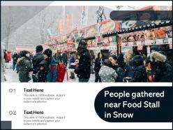 People gathered near food stall in snow
