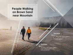 People walking on brown sand near mountain