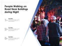People walking on road near buildings during night