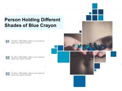 Person holding different shades of blue crayon