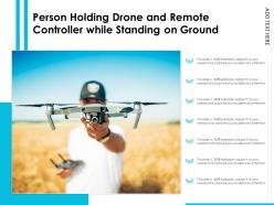 Person holding drone and remote controller while standing on ground