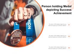 Person holding medal depicting success achievement