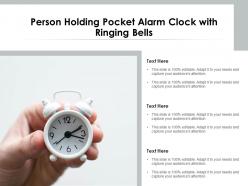 Person holding pocket alarm clock with ringing bells