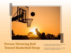 Person throwing ball toward basketball hoop