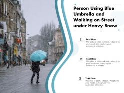 Person using blue umbrella and walking on street under heavy snow