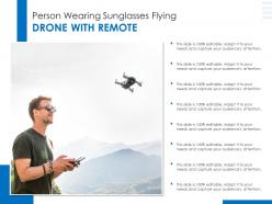 Person wearing sunglasses flying drone with remote
