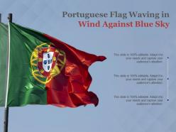 Portuguese flag waving in wind against blue sky