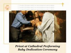 Priest at cathedral performing baby dedication ceremony
