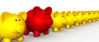 Queue of piggies with one red piggy coming out from line as leader stock photo