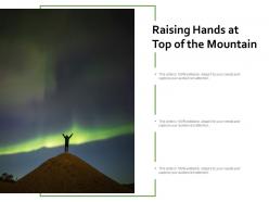 Raising hands at top of the mountain