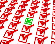 Red colored checklist with one green cross stock photo