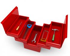 Red colored tool box with hammer wrench and spanner stock photo