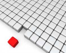 Red cube with multiple white cubes shows leadership stock photo