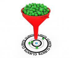 Red funnel with green balls targeting on clients stock photo