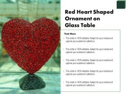 Red heart shaped ornament on glass table