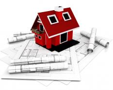 Red Model Of House With Construction Maps For Architecture Stock Photo