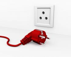 Red plug for electric connection showing technology stock photo