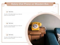Rotary dial phone on wooden box