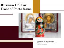 Russian doll in front of photo frame