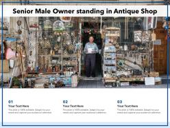 Senior male owner standing in antique shop