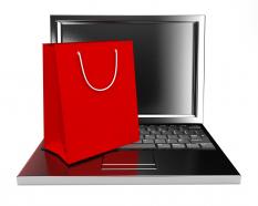 Shopping bags in red color and laptop stock photo
