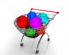 Shopping cart full with colored balls stock photo