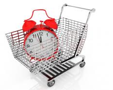 Shopping Cart With Clock For Timely Shopping Concept Stock Photo